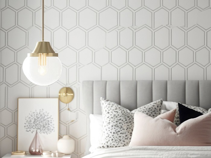 Modern, neutral colored bedroom with honeycomb shapes on the wallpaper.